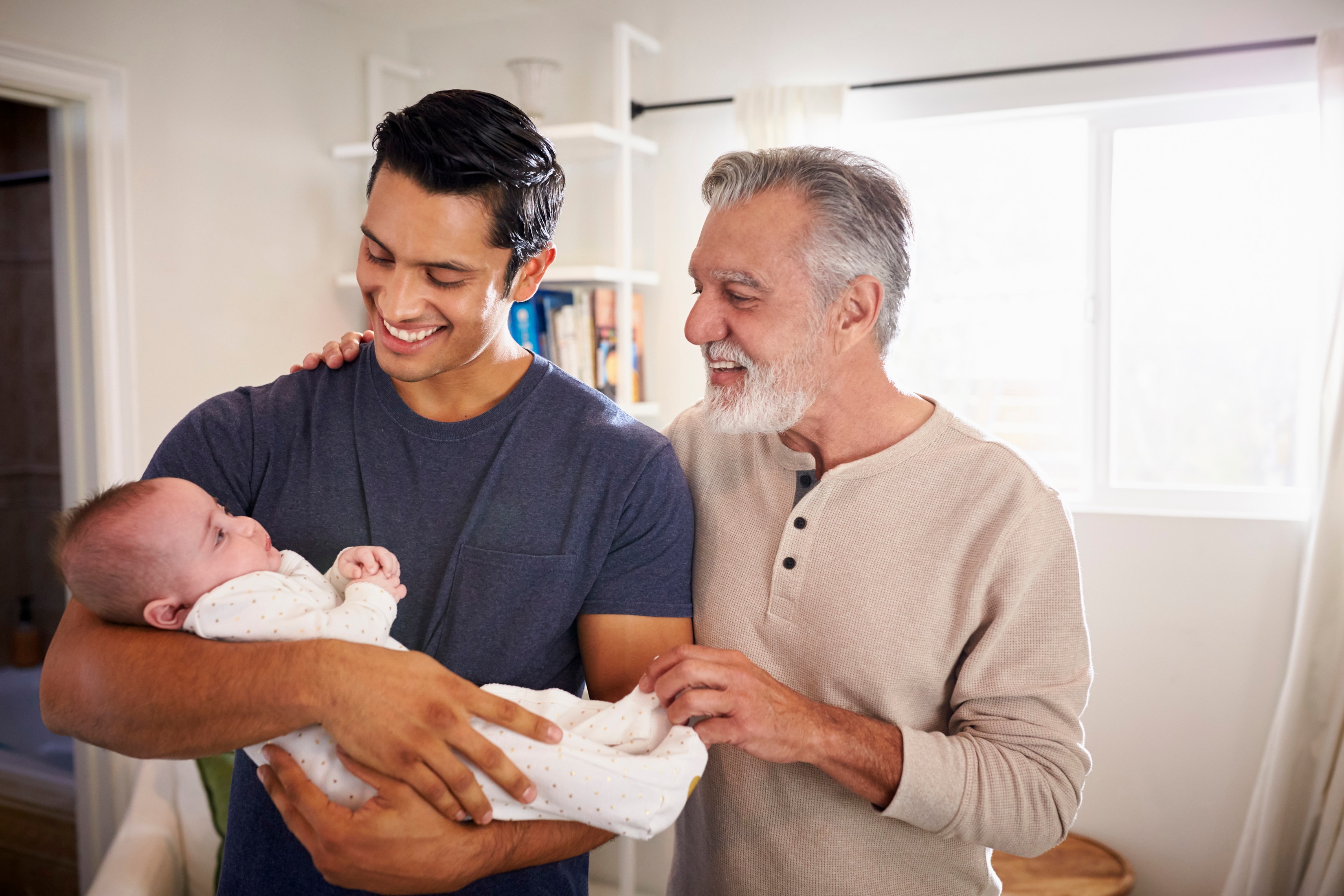 Father holding infant son with his father: three generations