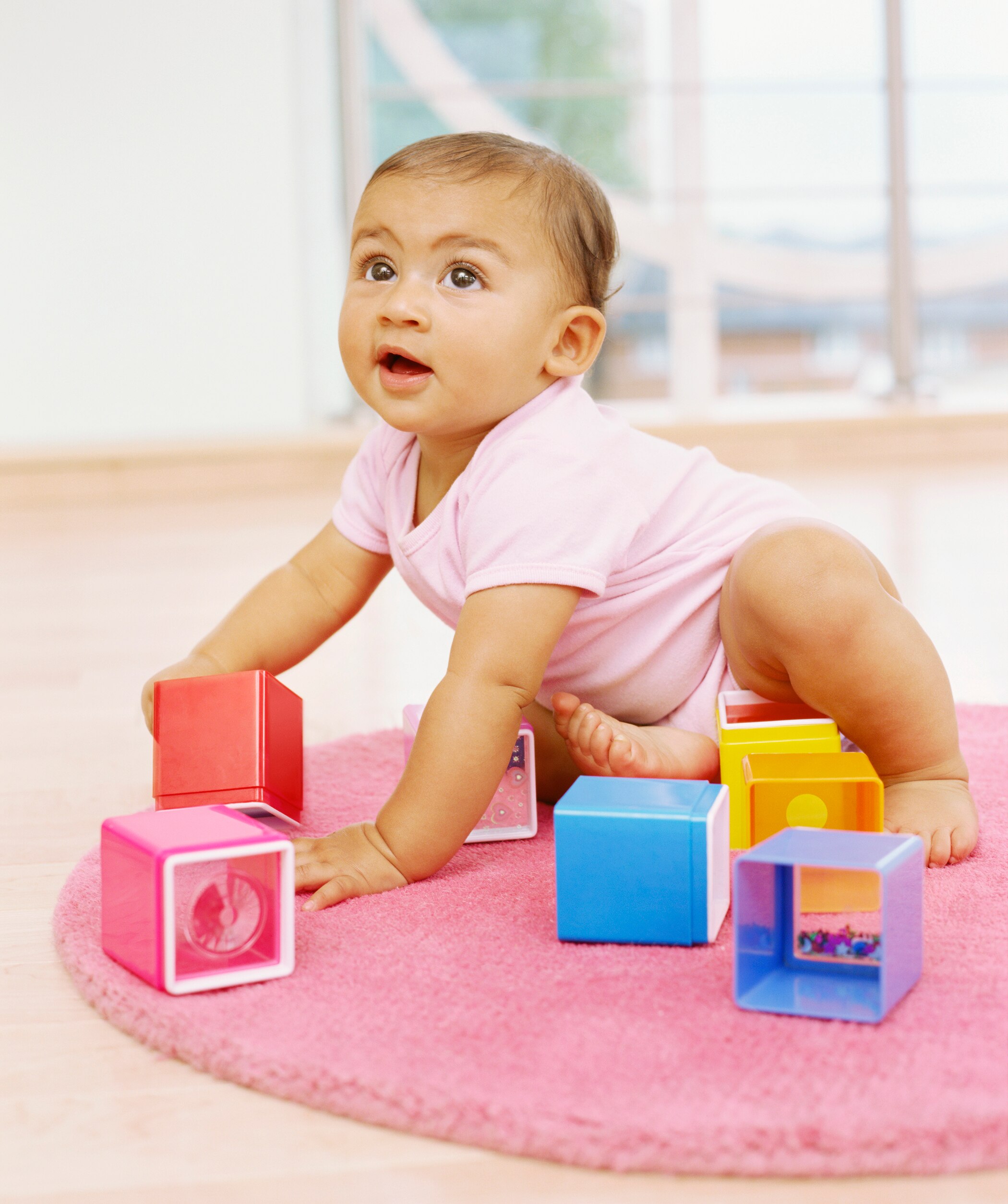 Baby girl playing with blocks