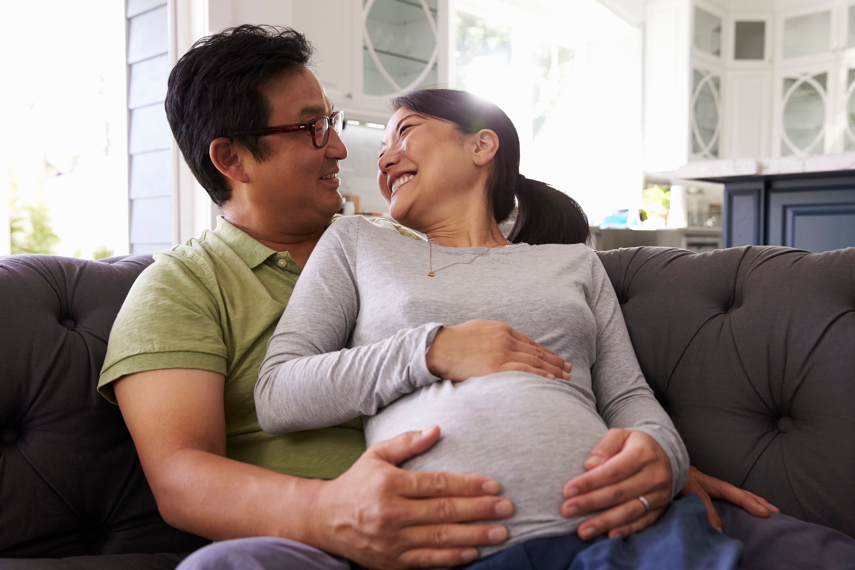 Happy expectant couple sharing joy of pregnancy