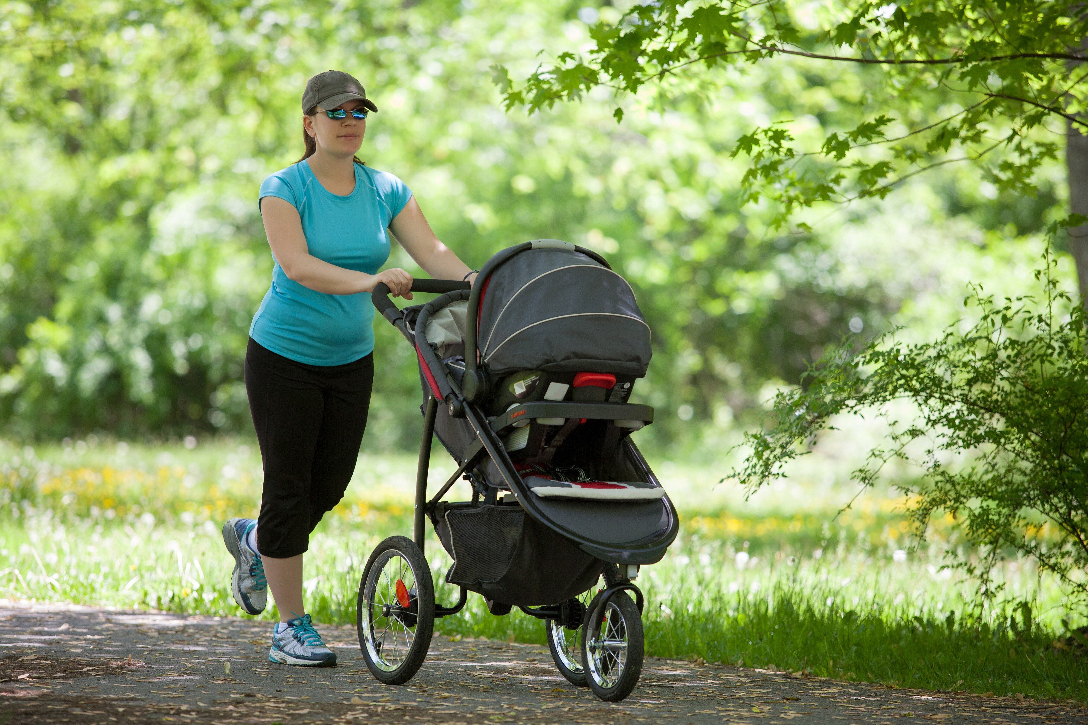mother walking baby in exercise stroller